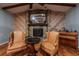 Stone fireplace flanked by wingback chairs in living room at 531 Garrard Dr, Temple Terrace, FL 33617