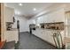 Modern kitchen featuring white cabinets, granite countertops, and black appliances at 531 Garrard Dr, Temple Terrace, FL 33617