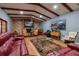 Spacious living room with hardwood floors, exposed beams, and sectional sofa at 531 Garrard Dr, Temple Terrace, FL 33617