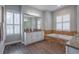 Spa-like bathroom with soaking tub, double vanities, and plenty of natural light at 6020 Kestrel Point Ave, Lithia, FL 33547
