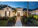 Well-lit entrance with brick walkway and lush landscaping at 6020 Kestrel Point Ave, Lithia, FL 33547