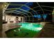 Night view of a refreshing pool and spa with a covered patio at 6020 Kestrel Point Ave, Lithia, FL 33547