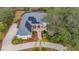 Aerial view of house with solar panels and pool; landscaped yard, long driveway at 6114 Kingbird Manor Dr, Lithia, FL 33547