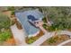 Aerial view of house with solar panels and pool; landscaped yard and driveway at 6114 Kingbird Manor Dr, Lithia, FL 33547
