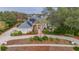 House with solar panels and landscaped yard; long driveway at 6114 Kingbird Manor Dr, Lithia, FL 33547