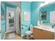 Bathroom with walk-in shower, toilet, vanity, and access to the backyard at 6114 Kingbird Manor Dr, Lithia, FL 33547