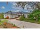 House exterior with solar panels and manicured landscaping at 6114 Kingbird Manor Dr, Lithia, FL 33547