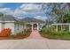 Elegant front entry with brick walkway and pergola at 6114 Kingbird Manor Dr, Lithia, FL 33547