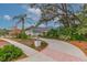 Landscaped front yard with circular driveway and solar panels at 6114 Kingbird Manor Dr, Lithia, FL 33547