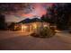 Night view of home's side, showcasing garage and landscaping at 6114 Kingbird Manor Dr, Lithia, FL 33547