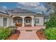 Single story home with a covered entry and brick walkway at 6114 Kingbird Manor Dr, Lithia, FL 33547