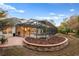 Screened-in pool and spa with a brick patio and landscaping at 6114 Kingbird Manor Dr, Lithia, FL 33547