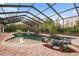 Expansive screened pool and spa with a large patio area at 6114 Kingbird Manor Dr, Lithia, FL 33547