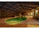 Night view of kidney shaped pool with screened enclosure at 6114 Kingbird Manor Dr, Lithia, FL 33547