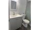 Modern bathroom with gray vanity and new toilet at 7638 Woodbridge Blvd, Tampa, FL 33615