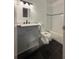 Updated bathroom with gray vanity and dark tile floors at 7638 Woodbridge Blvd, Tampa, FL 33615