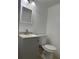 Clean bathroom with gray vanity, toilet, and mirror at 7638 Woodbridge Blvd, Tampa, FL 33615