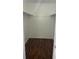 Walk-in closet with double hanging rods and wood-look flooring at 7638 Woodbridge Blvd, Tampa, FL 33615