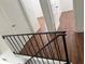 Upper level hallway with laminate wood floors at 7638 Woodbridge Blvd, Tampa, FL 33615