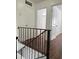 Upper level hallway with laminate wood floors and doors to bedrooms at 7638 Woodbridge Blvd, Tampa, FL 33615
