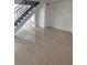 Bright living room with tile floors and staircase at 7638 Woodbridge Blvd, Tampa, FL 33615