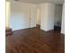 Large main bedroom with laminate wood floors and access to bathroom at 7638 Woodbridge Blvd, Tampa, FL 33615