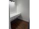 Small office space with built-in desk and drawers, wood-look flooring at 7638 Woodbridge Blvd, Tampa, FL 33615