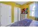 Bedroom with yellow walls, double doors, and a dresser at 8755 Commodore Dr, Seminole, FL 33776
