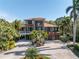 Luxury waterfront home boasting a stunning exterior and lush landscaping at 8755 Commodore Dr, Seminole, FL 33776