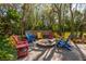 Colorful Adirondack chairs around a fire pit on a brick patio at 8755 Commodore Dr, Seminole, FL 33776