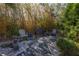 Stone patio sitting area with chairs and a bamboo backdrop at 8755 Commodore Dr, Seminole, FL 33776