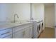 Laundry room with white cabinets, quartz countertop, and stackable washer/dryer at 920 N Osceola Ave # 507, Clearwater, FL 33755