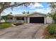 Single story home with a two-car garage and nicely landscaped yard at 974 Phyllis Ave, Largo, FL 33771