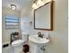 Clean bathroom with pedestal sink, toilet, and shower at 1022 Canal St, Ruskin, FL 33570