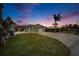 Inviting single-story home with a two-car garage and well-manicured lawn at 1022 Canal St, Ruskin, FL 33570