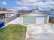 House exterior featuring a light green color, attached garage, and walkway at 1022 Canal St, Ruskin, FL 33570