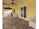 Covered patio with brick pavers, French doors, ceiling fan at 11325 5Th E St, Treasure Island, FL 33706