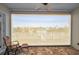 Covered balcony offering water views; features a comfortable chair and ottoman at 11325 5Th E St, Treasure Island, FL 33706