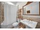 Clean bathroom with a pedestal sink, toilet, and shower/tub combo at 11325 5Th E St, Treasure Island, FL 33706