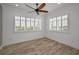 Bright bedroom with wood flooring, ceiling fan, and plantation shutters at 11325 5Th E St, Treasure Island, FL 33706