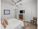 Bright bedroom with a comfortable bed and TV at 11325 5Th E St, Treasure Island, FL 33706