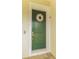 Green front door with a seashell wreath at 11325 5Th E St, Treasure Island, FL 33706
