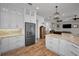 Open kitchen features granite countertops, white cabinetry, and stainless steel appliances at 11325 5Th E St, Treasure Island, FL 33706