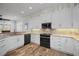 Spacious kitchen with granite countertops, white cabinets, and stainless steel appliances at 11325 5Th E St, Treasure Island, FL 33706