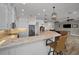 Kitchen with breakfast bar, granite countertops and white shaker cabinets at 11325 5Th E St, Treasure Island, FL 33706