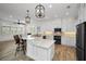 Island kitchen with breakfast bar, granite countertops, and stainless steel appliances at 11325 5Th E St, Treasure Island, FL 33706
