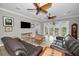 Spacious living room with hardwood floors, comfortable seating, and access to a balcony at 11325 5Th E St, Treasure Island, FL 33706