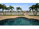 Irregular shaped pool with a spa and waterfront view at 11325 5Th E St, Treasure Island, FL 33706