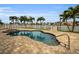 Inviting kidney-shaped pool with spa and paver deck at 11325 5Th E St, Treasure Island, FL 33706