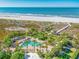 Aerial view of resort pool area, beach access, and boardwalk at 1180 Gulf Blvd # 1603, Clearwater Beach, FL 33767